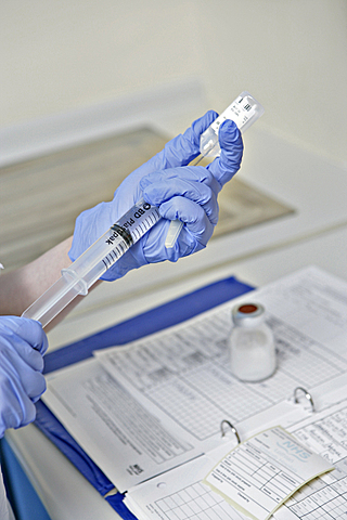clinician hands using syringe